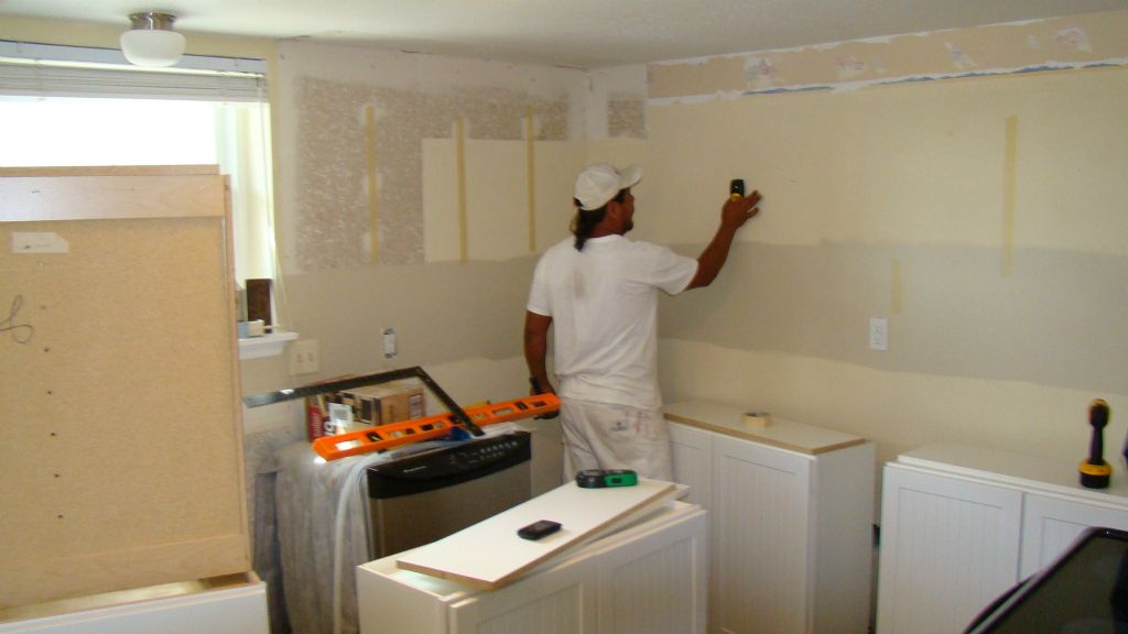 Prepping walls prior to hanging cabinets